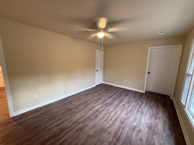 unfurnished bedroom with ceiling fan and dark hardwood / wood-style floors