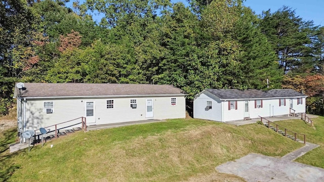 rear view of property with a yard