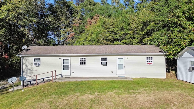 back of house with a lawn and a patio area