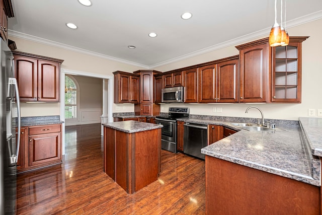 kitchen with dark hardwood / wood-style floors, stainless steel appliances, sink, crown molding, and decorative light fixtures