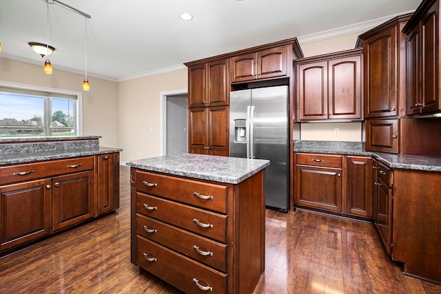 kitchen with a center island, dark wood-type flooring, pendant lighting, ornamental molding, and stainless steel refrigerator with ice dispenser