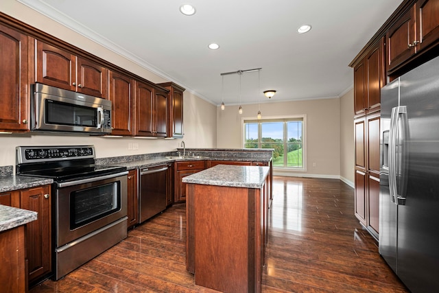 kitchen with a kitchen island, light stone counters, dark hardwood / wood-style floors, stainless steel appliances, and crown molding