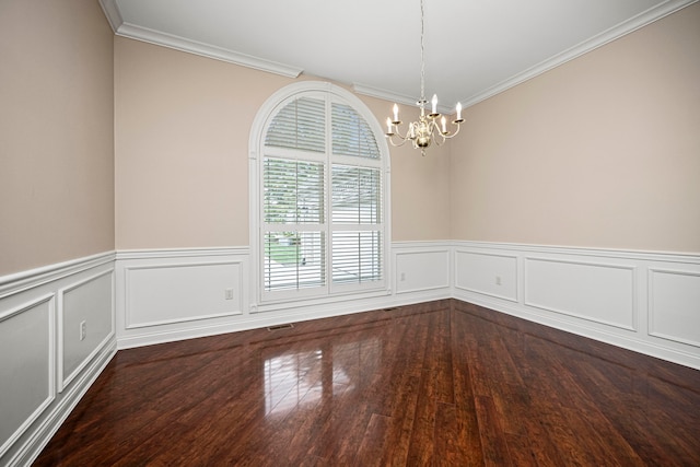 unfurnished room with ornamental molding, a notable chandelier, and wood-type flooring