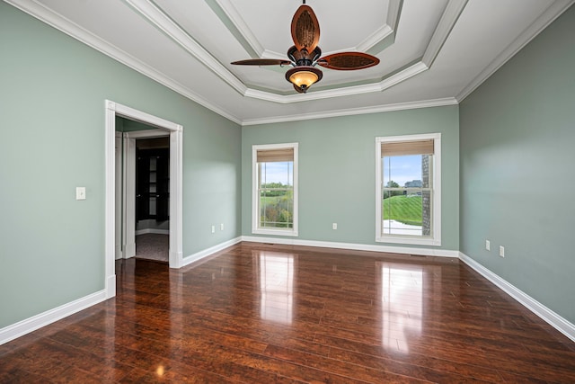 empty room with ornamental molding, ceiling fan, and dark hardwood / wood-style floors