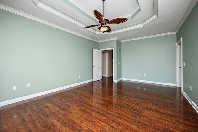 unfurnished bedroom with ceiling fan, a raised ceiling, dark hardwood / wood-style floors, and crown molding