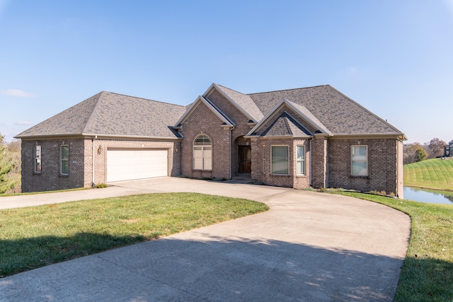 view of front of home with a garage and a front lawn