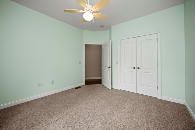 unfurnished bedroom featuring ceiling fan, carpet floors, and a closet