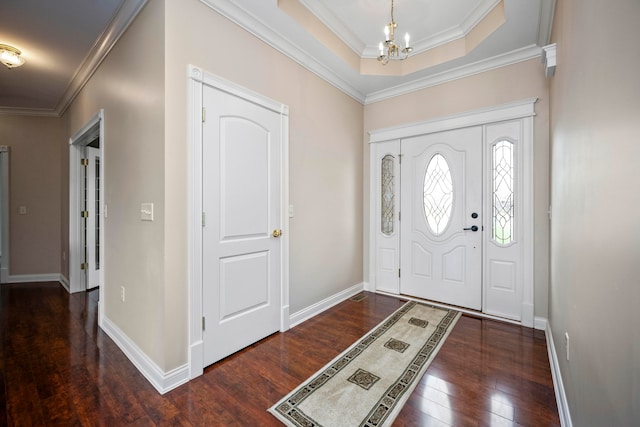 foyer featuring ornamental molding, a notable chandelier, and dark hardwood / wood-style flooring