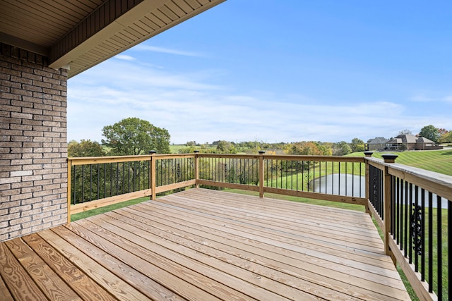 wooden terrace featuring a water view