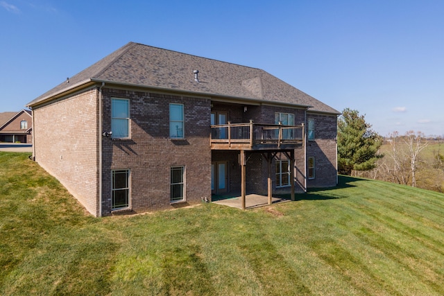 rear view of house with a lawn and a patio area