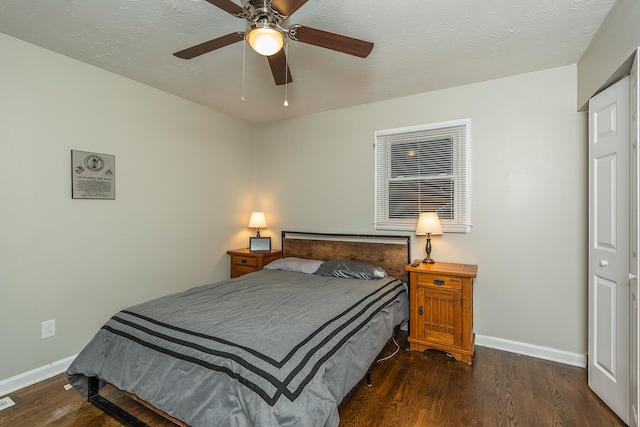 bedroom featuring a closet, dark hardwood / wood-style flooring, a textured ceiling, and ceiling fan