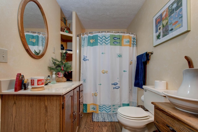 bathroom featuring hardwood / wood-style floors, vanity, a shower with curtain, toilet, and a textured ceiling