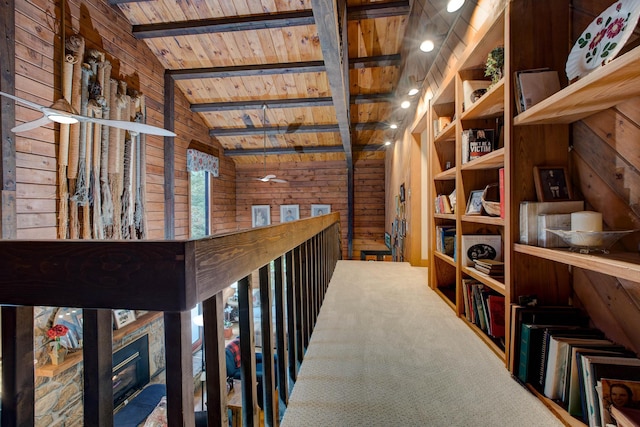 interior space with vaulted ceiling with beams, wood ceiling, and wooden walls