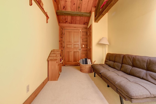 carpeted living room featuring vaulted ceiling with beams and wood ceiling