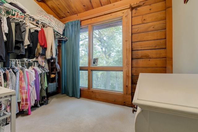 spacious closet with light colored carpet and vaulted ceiling