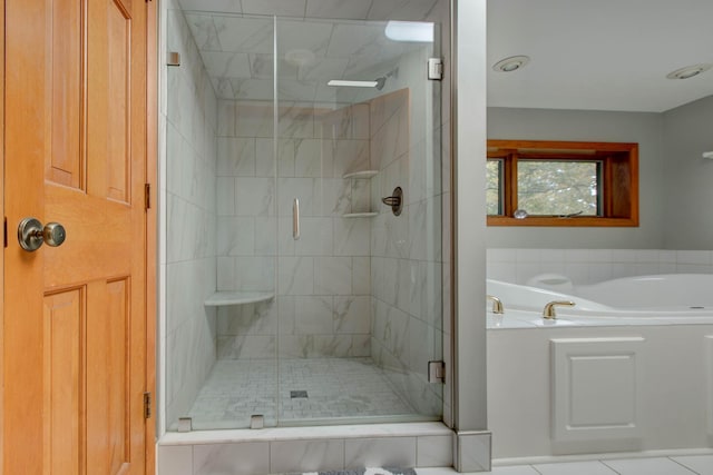 bathroom featuring tile patterned flooring and independent shower and bath