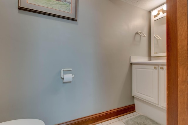 bathroom with a textured ceiling, vanity, and tile patterned floors