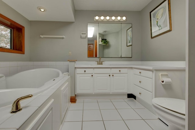 bathroom featuring tile patterned flooring, vanity, toilet, and a bathing tub