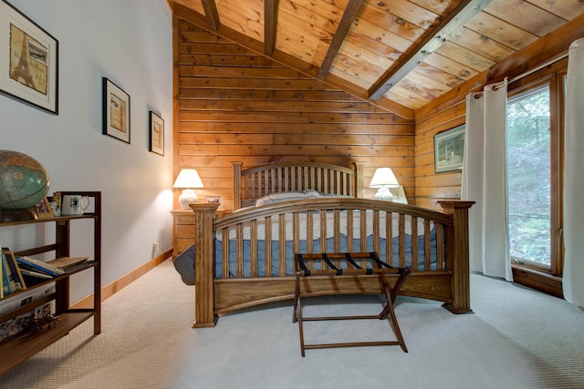 bedroom featuring lofted ceiling with beams, light colored carpet, wooden walls, and wood ceiling