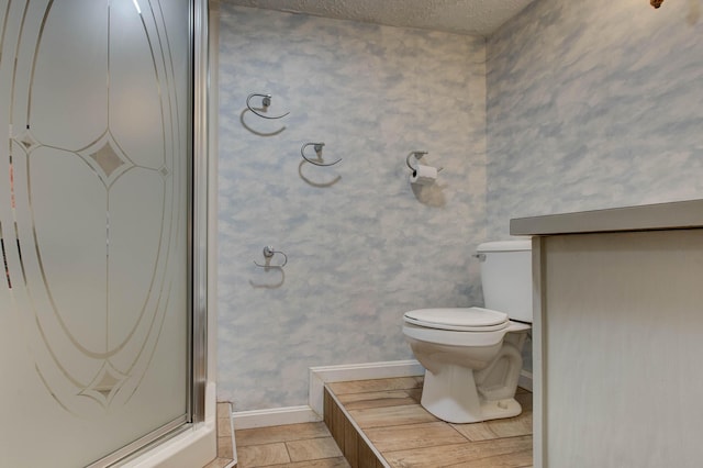 bathroom featuring toilet and a textured ceiling