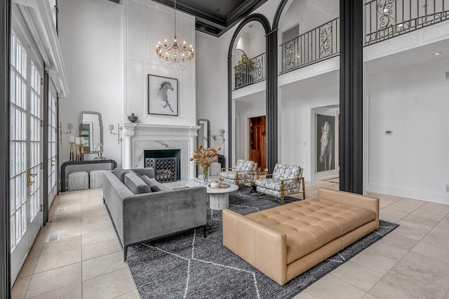 tiled living room featuring a towering ceiling, ornamental molding, a chandelier, and a wealth of natural light