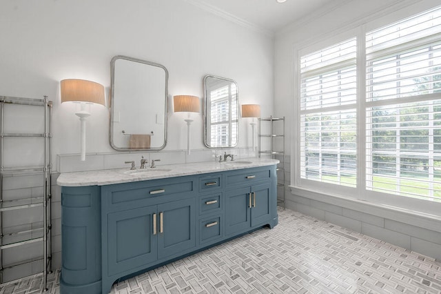 bathroom with vanity, ornamental molding, and tile walls