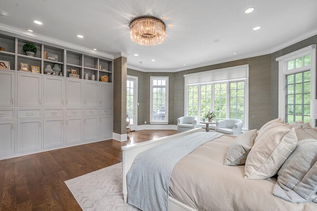 bedroom with dark wood-type flooring, crown molding, and a chandelier