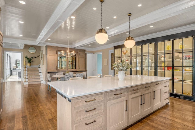 kitchen featuring a spacious island, light hardwood / wood-style flooring, beam ceiling, and pendant lighting