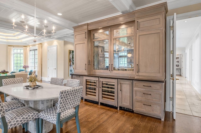 dining space with ornamental molding, hardwood / wood-style floors, beamed ceiling, and beverage cooler