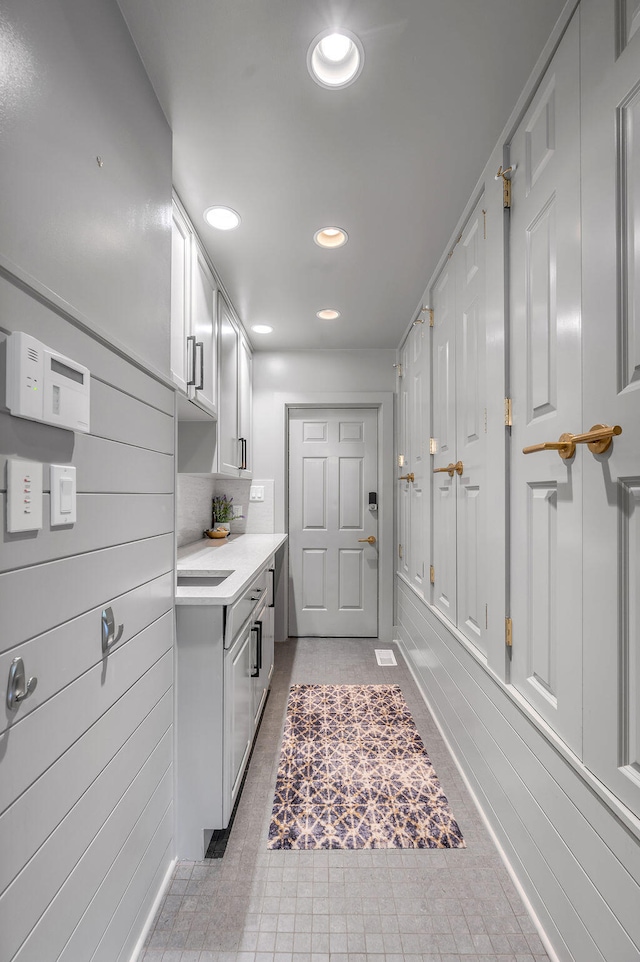 laundry area with sink and light tile patterned floors