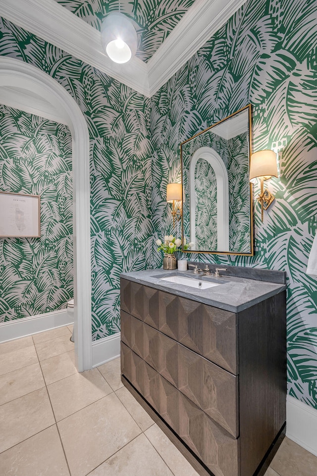 bathroom with vanity, toilet, crown molding, and tile patterned flooring