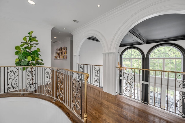 hallway with ornamental molding and hardwood / wood-style flooring