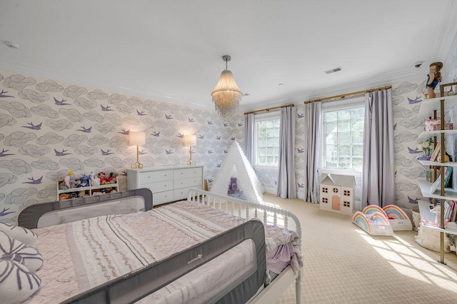 bedroom with ornamental molding, a notable chandelier, and carpet flooring