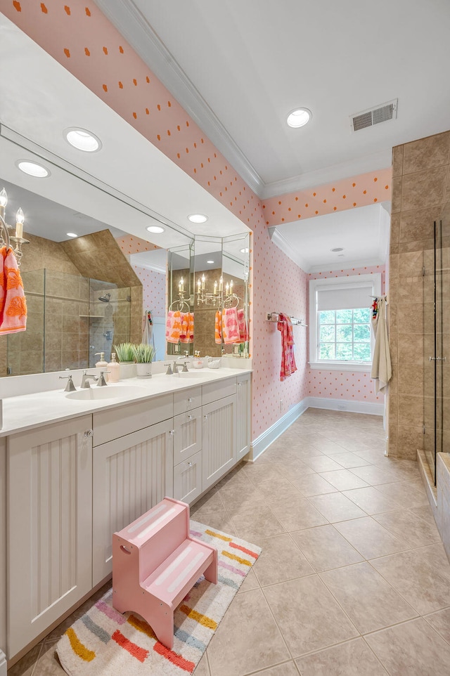 bathroom with vanity, crown molding, tile patterned flooring, and a shower with door