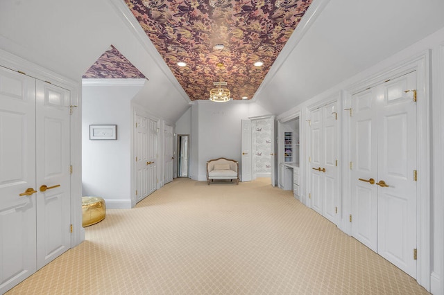 hall featuring ornamental molding, light colored carpet, and vaulted ceiling