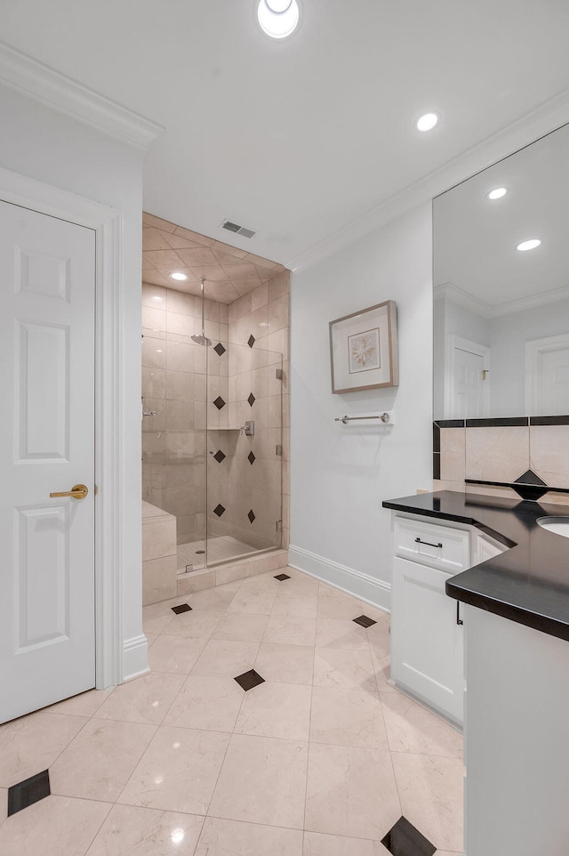 bathroom featuring vanity, crown molding, tile patterned floors, and a shower with shower door