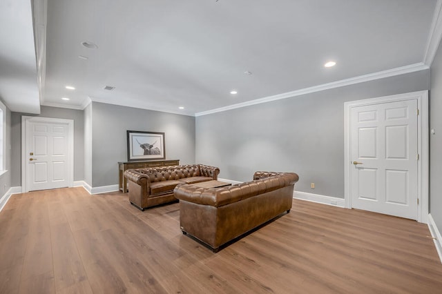 living room with light hardwood / wood-style floors and ornamental molding