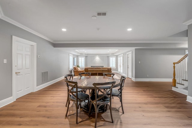 dining room featuring crown molding and light wood-type flooring