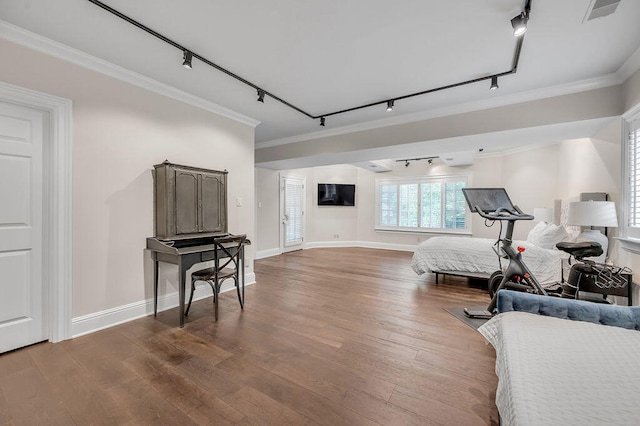 workout room with crown molding, hardwood / wood-style flooring, and track lighting