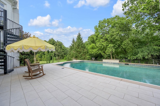 view of swimming pool featuring a patio area