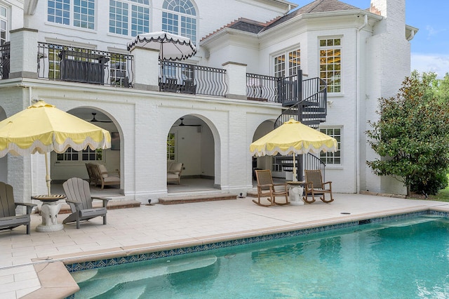 rear view of house with a balcony and a patio