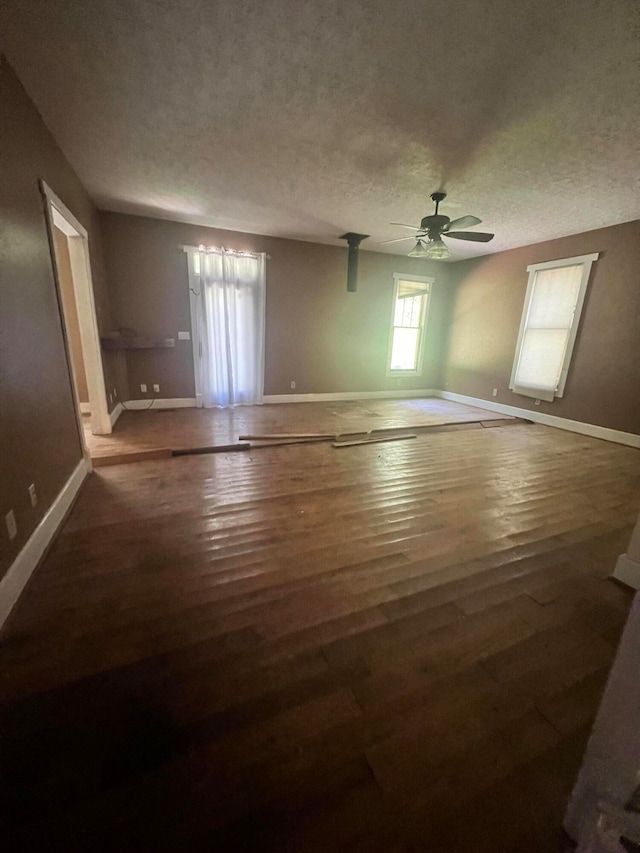 empty room with wood-type flooring, a textured ceiling, and ceiling fan