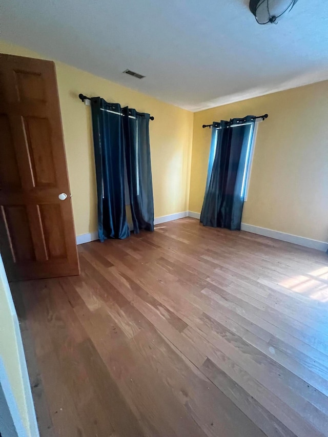 empty room featuring wood-type flooring