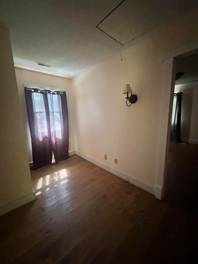 spare room with wood-type flooring