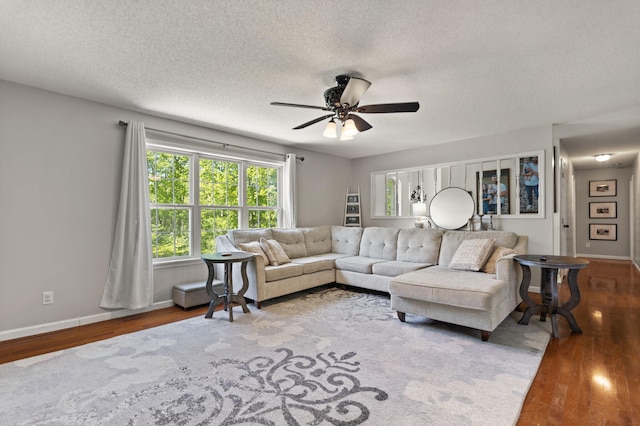 living room featuring a textured ceiling, hardwood / wood-style flooring, and ceiling fan