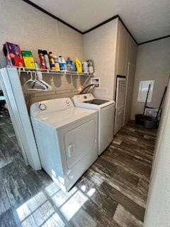 laundry area featuring dark wood-type flooring and washing machine and clothes dryer