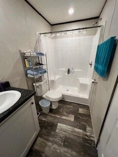 bathroom featuring a shower with shower curtain, vanity, and toilet