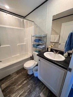 full bathroom featuring toilet, shower / tub combo, hardwood / wood-style floors, and vanity