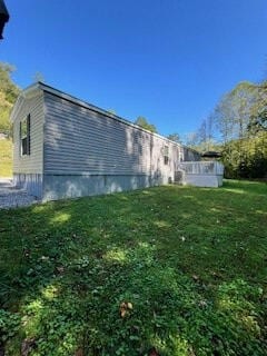 view of side of property with a lawn