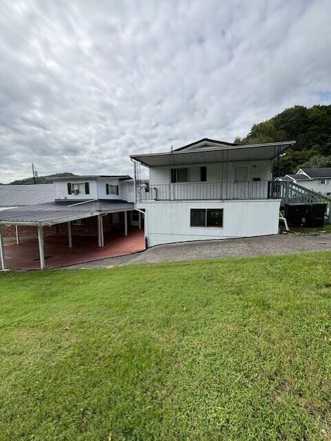 rear view of house featuring a yard